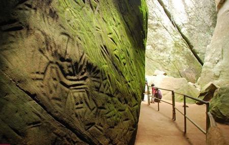 Explore the historic Edakkal Caves with Budget-friendly resorts in Wayanad.
